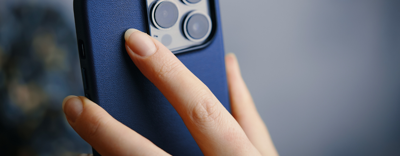 la main d'une femme qui tient un iphone 13